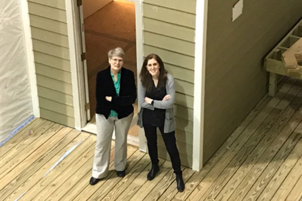 Researchers standing at the front entrance of HIL housing mockup