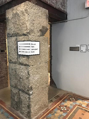 Wayfinding signage wrapped around concrete post