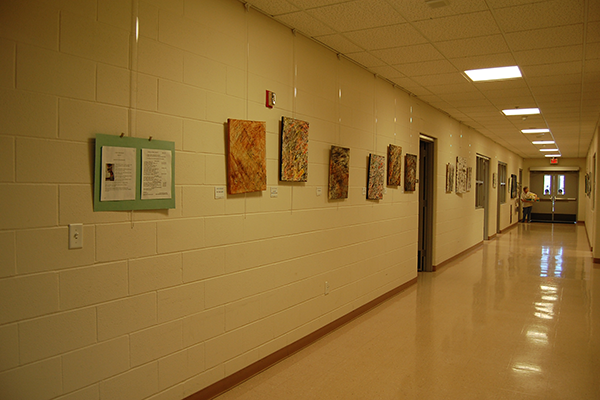 Amherst Senior Center hallway with paintings hanging